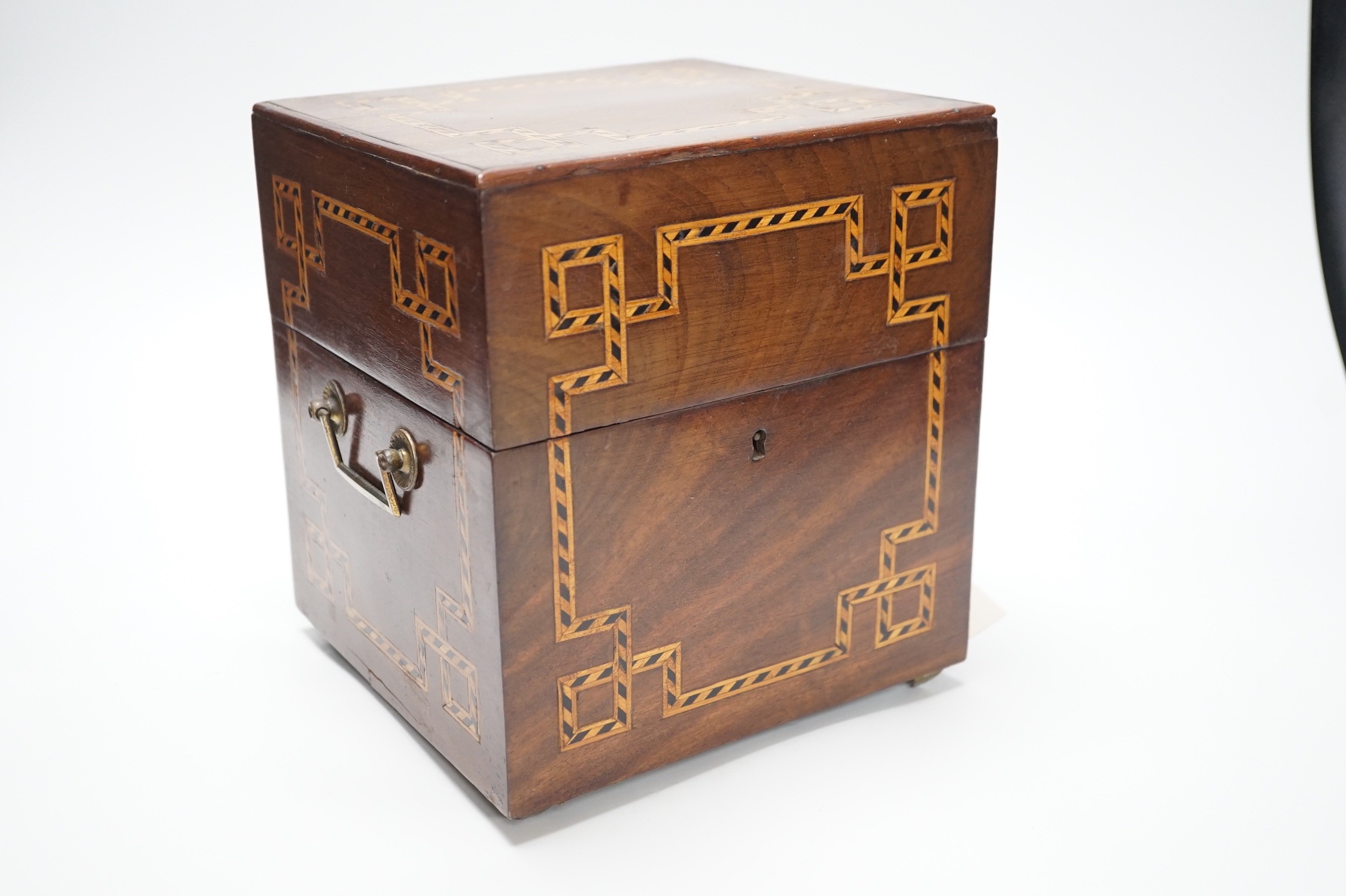 A George III inlaid mahogany decanter set with four gilt decorated decanters and two T.Goode & Co. enamelled wine labels, ‘BRANDY’ and ‘KÜMMEL’. 21cm tall